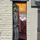 Mural of an old man peering out of an open door